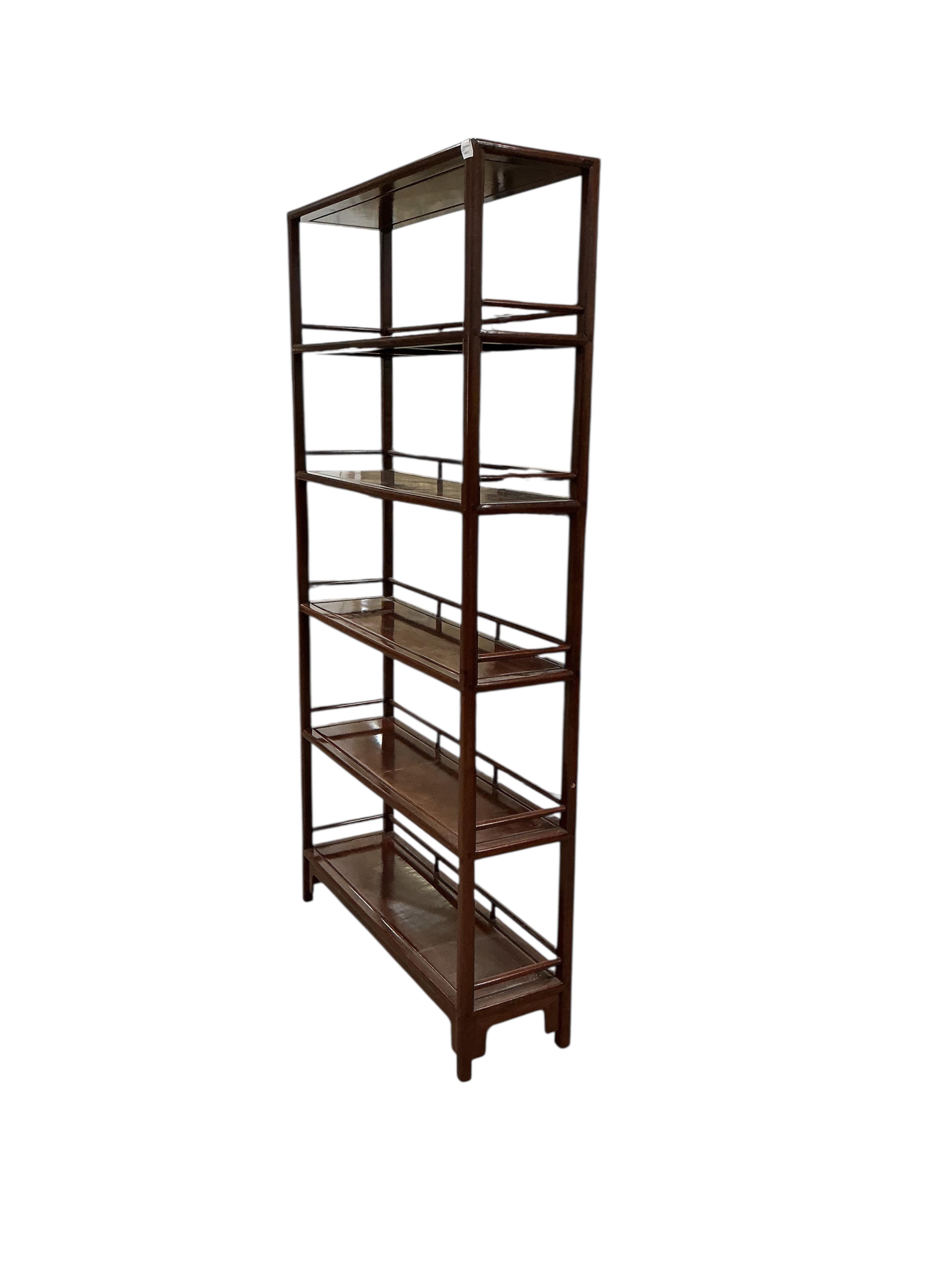 A Chinese hardwood open bookcase, width 100cm, depth 30cm, height 195cm